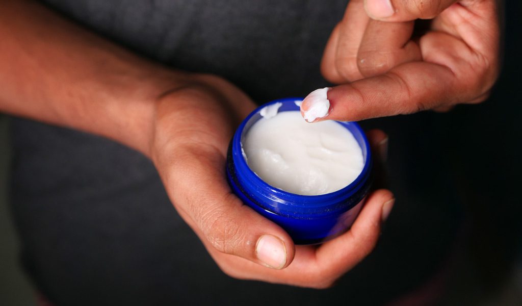 Man-holding-moisturizing-cream